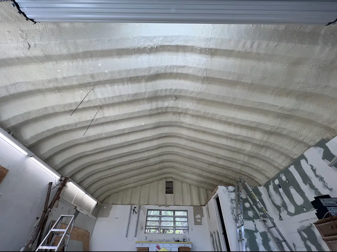 Spray polyurethane foam applied to the underside of a metal roof deck in Scaggsville